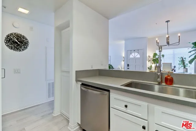 a kitchen with a sink and a refrigerator