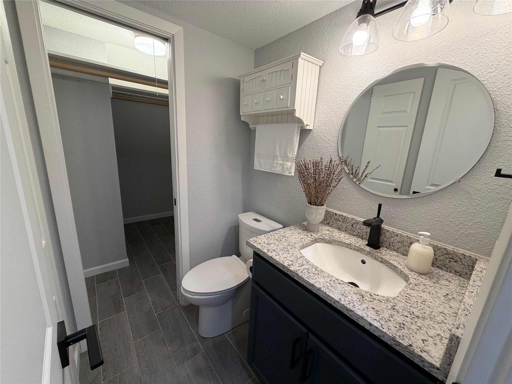 11301 Jollyville Road, Unit B3 Austin, TX 78759 - Photo 11 of 23 Bathroom with vanity, a textured ceiling, and a textured wall