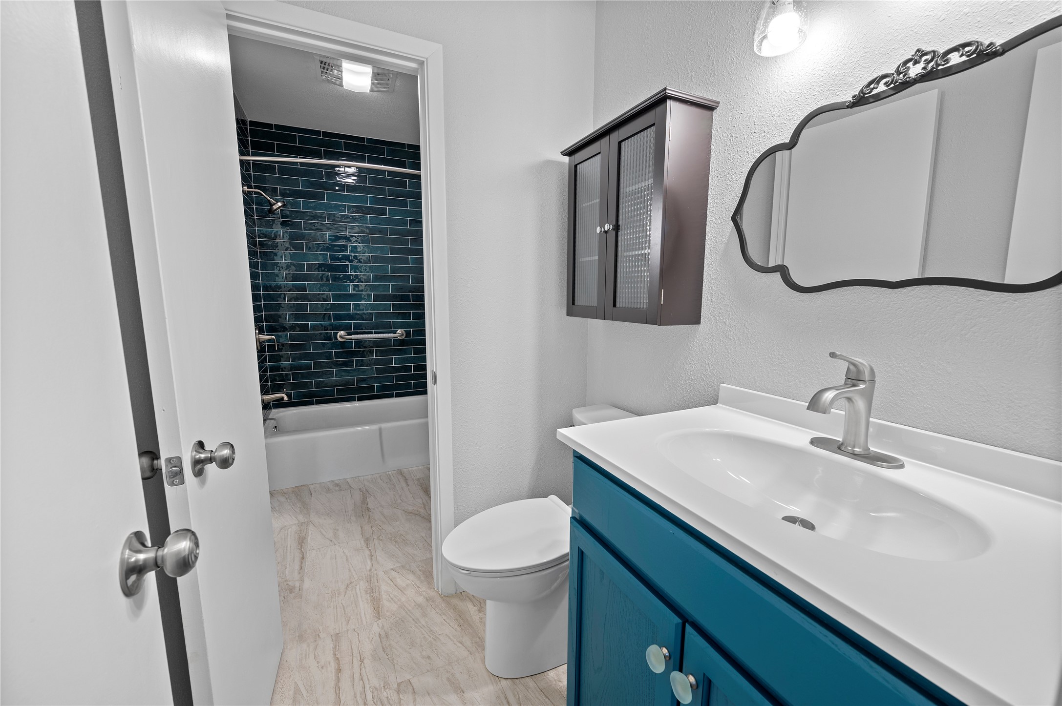 11301 Jollyville Road, Unit B3 Austin, TX 78759 - Photo 17 of 23 Bathroom with vanity, shower / tub combination, and a textured wall