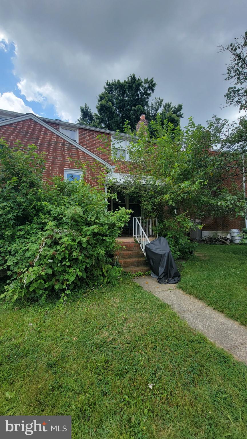 5105 Plymouth Road Baltimore, MD 21214 - Photo 7 of 29 Charming brick home with lush greenery.