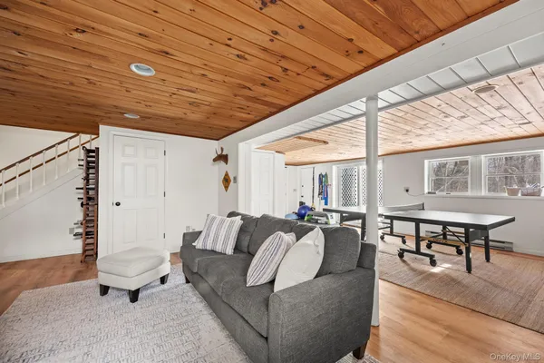 a living room with furniture a table and wooden floor