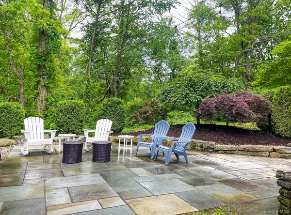 a view of a patio with chairs and table
