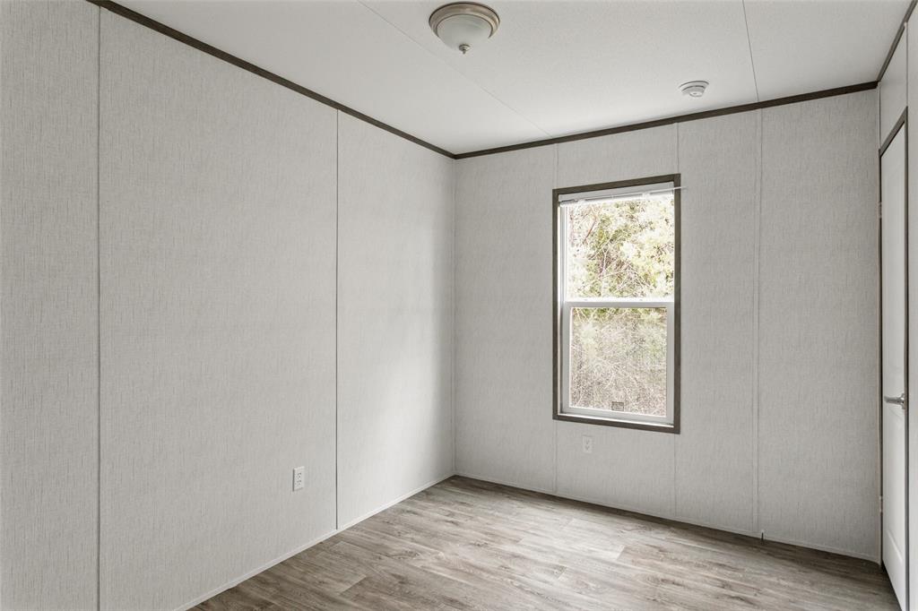 4510 Tennessee Trail Granbury, TX 76048 - Photo 19 of 25 a view of an empty room with wooden floor and a window