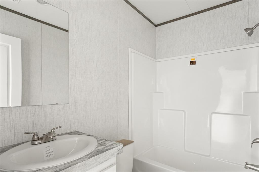 4510 Tennessee Trail Granbury, TX 76048 - Photo 21 of 25 a bathroom with a sink and a shower