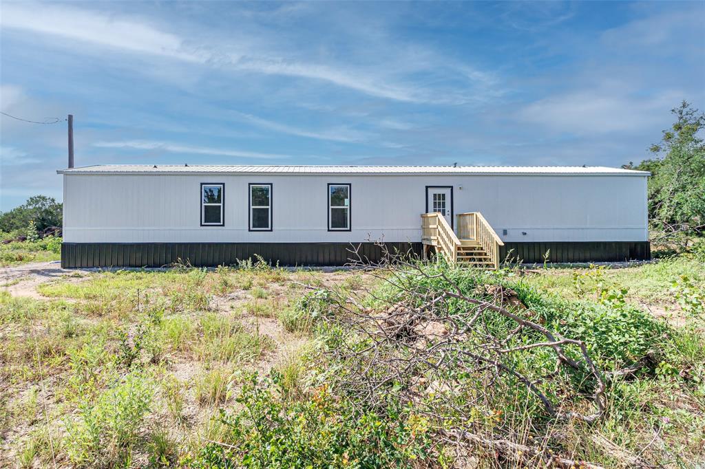 4510 Tennessee Trail Granbury, TX 76048 - Photo 25 of 25 a wooden bench sitting in front of a house