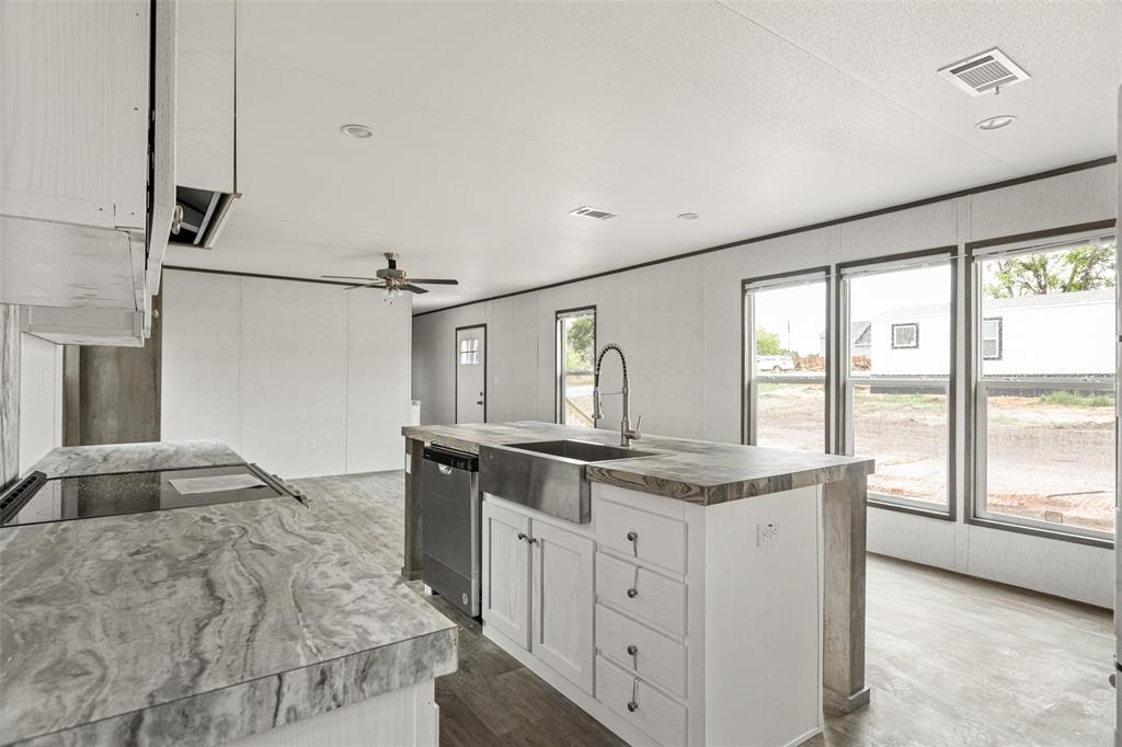 4510 Tennessee Trail Granbury, TX 76048 - Photo 8 of 25 a kitchen with granite countertop cabinets and window