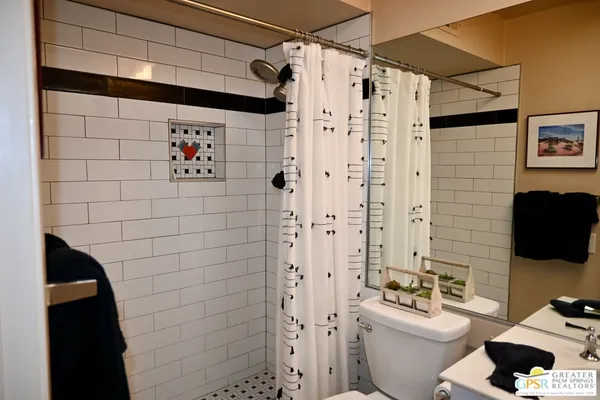 a white toilet sitting next to a bathroom sink