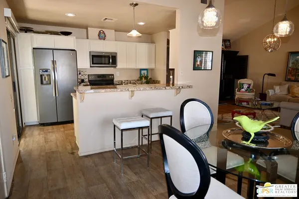 a kitchen with granite countertop a sink and a stove top oven