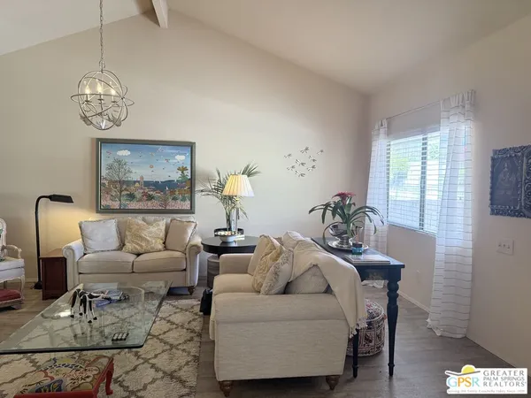 a living room with furniture a fireplace and a ceiling fan