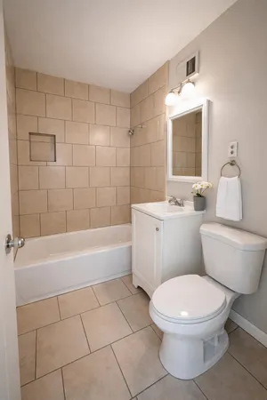 a bathroom with a toilet a sink and bathtub