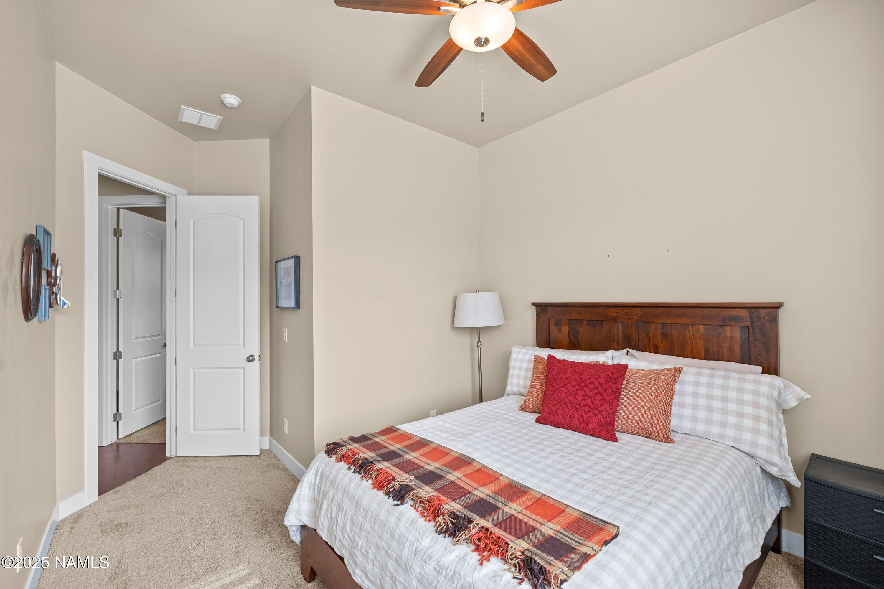 12030 Hydrus Road Bellemont, AZ 86015 - Photo 18 of 30 a bedroom with a bed and a chandelier