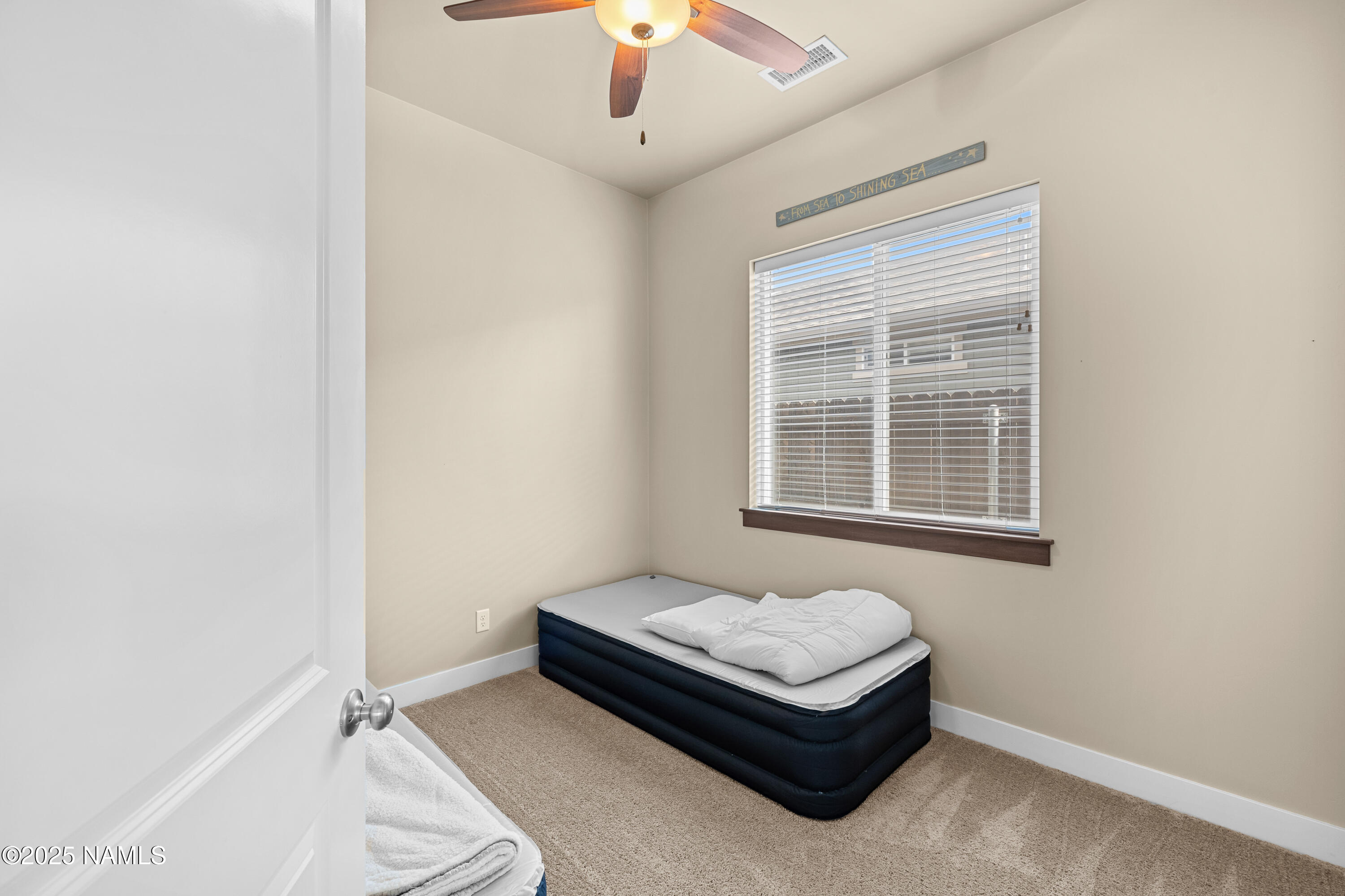 12030 Hydrus Road Bellemont, AZ 86015 - Photo 19 of 30 a living room with a bed furniture and a window