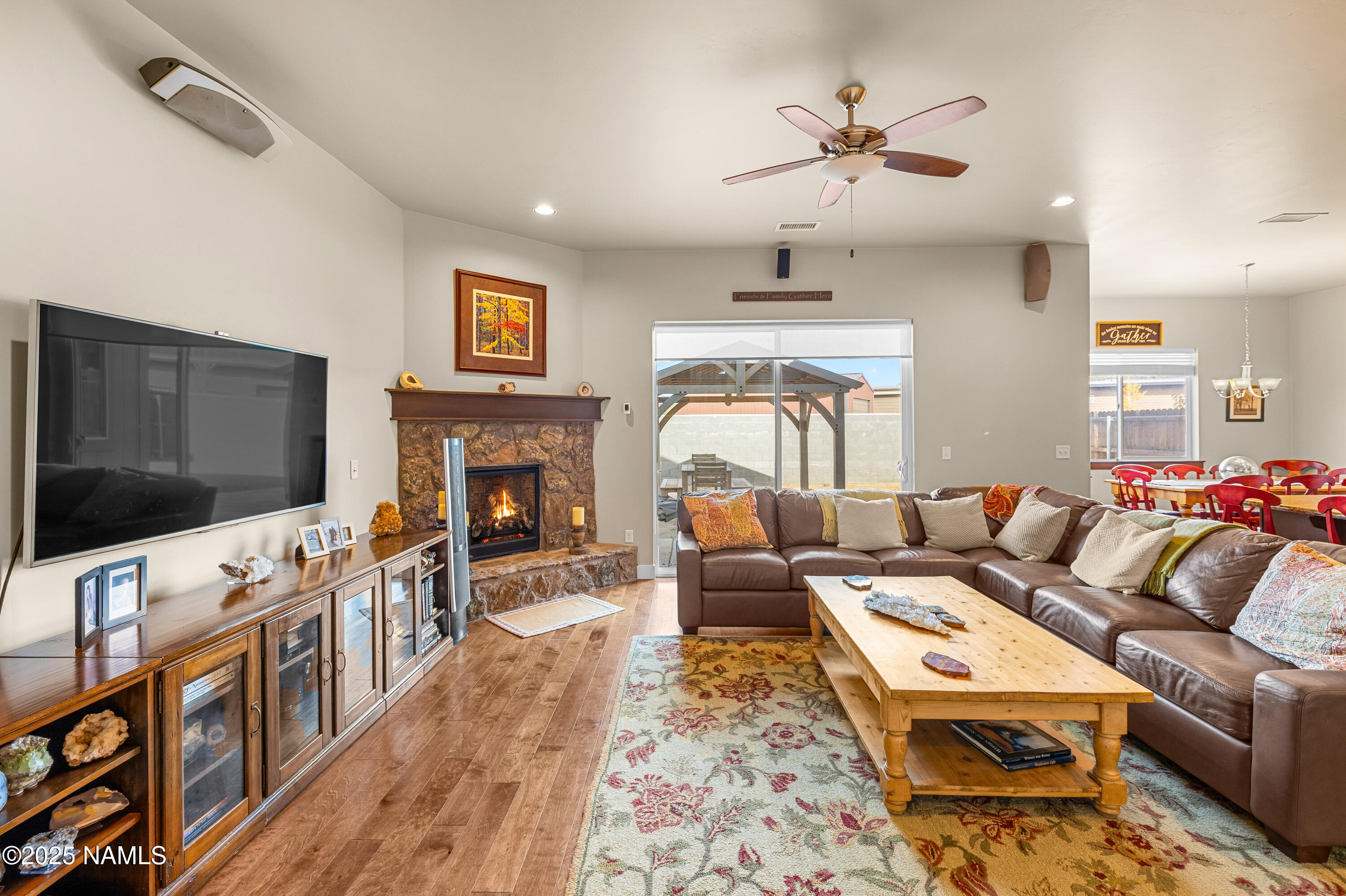12030 Hydrus Road Bellemont, AZ 86015 - Photo 4 of 30 a living room with furniture a flat screen tv and a fireplace