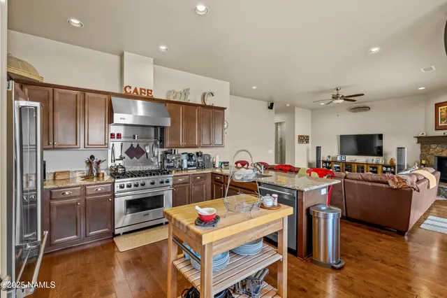a kitchen with a refrigerator sink and wooden cabinets