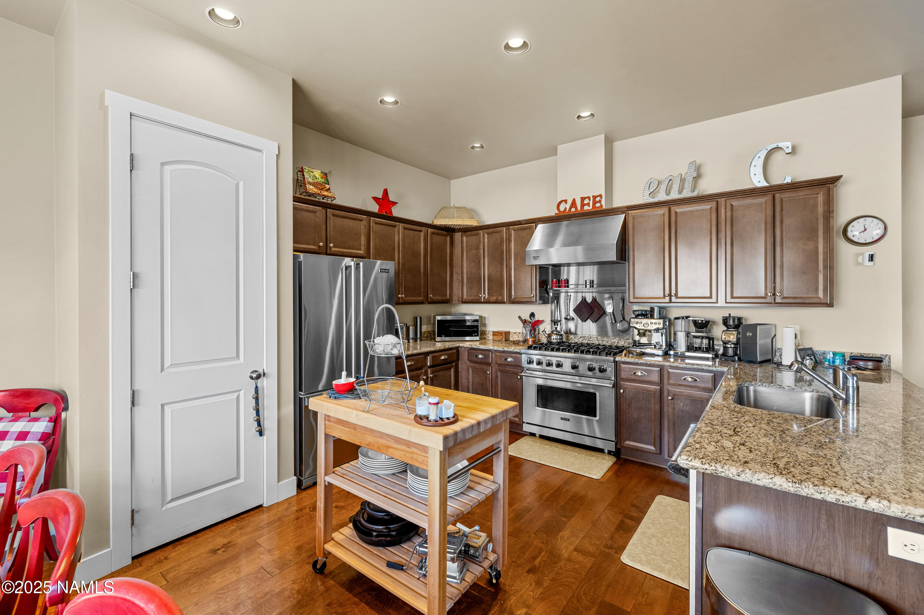 12030 Hydrus Road Bellemont, AZ 86015 - Photo 8 of 30 a kitchen with a refrigerator sink and wooden cabinets
