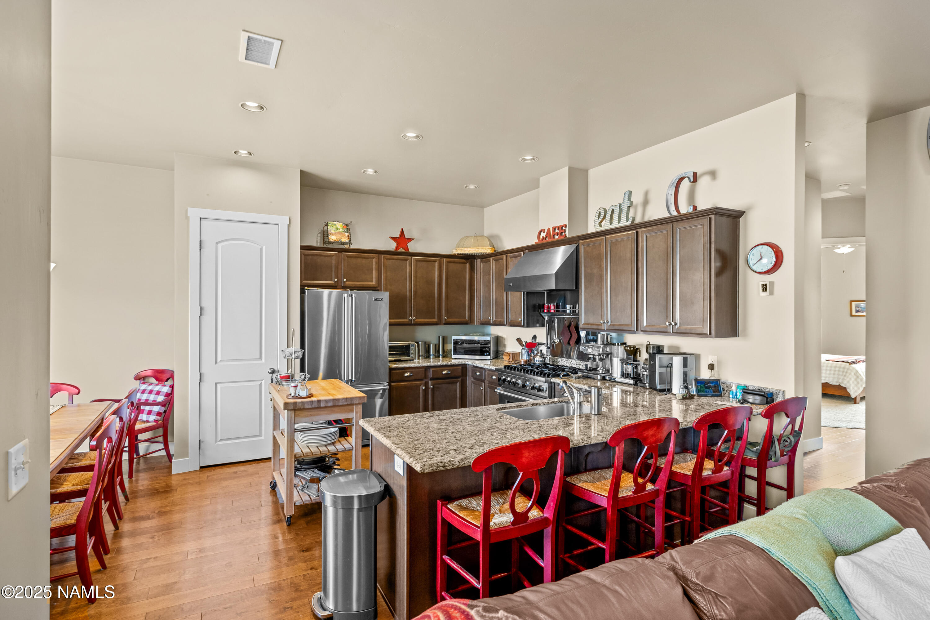 12030 Hydrus Road Bellemont, AZ 86015 - Photo 9 of 30 a living room with furniture kitchen view and a wooden floor