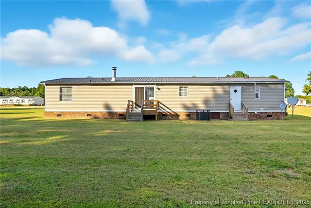 a view of a backyard with plants and lake view