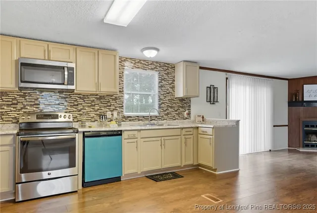 a kitchen with a sink stove and microwave