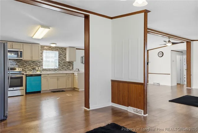 a kitchen with stainless steel appliances a refrigerator and a stove