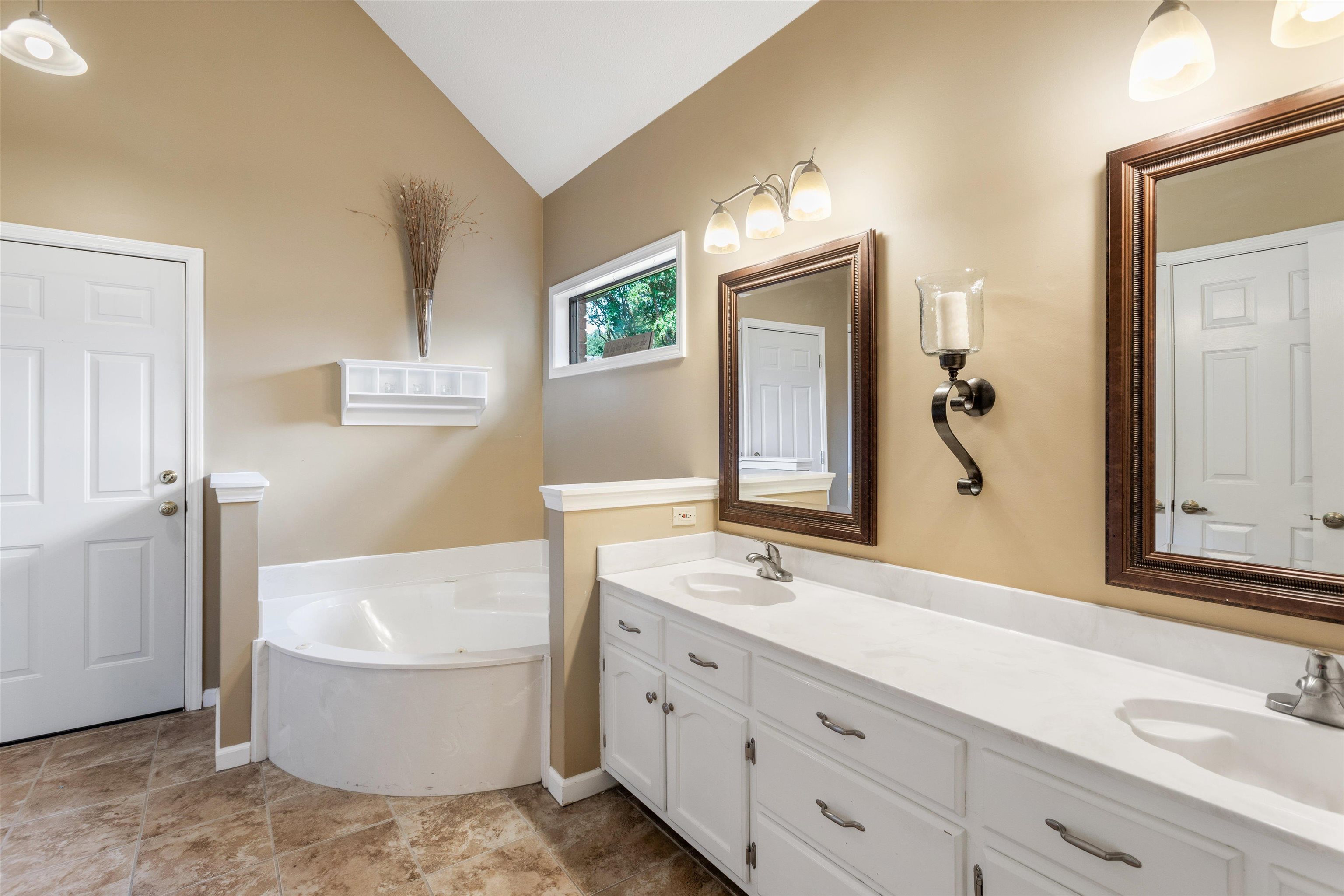 6614 Stephan Ridge Cove Bartlett, TN 38135 - Photo 11 of 26 a bathroom with a tub sink and mirror