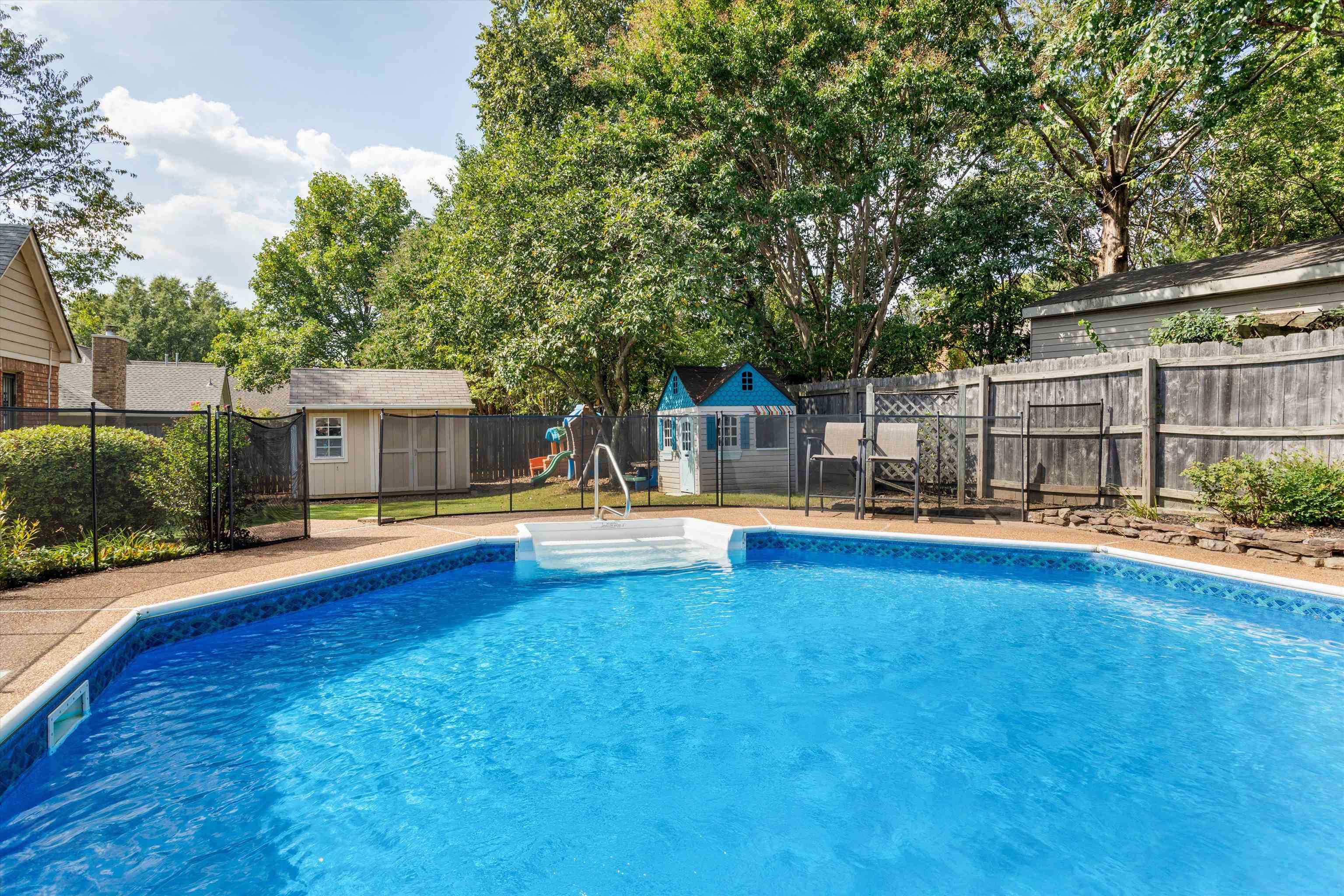 6614 Stephan Ridge Cove Bartlett, TN 38135 - Photo 24 of 26 a view of pool with lawn chairs and wooden fence
