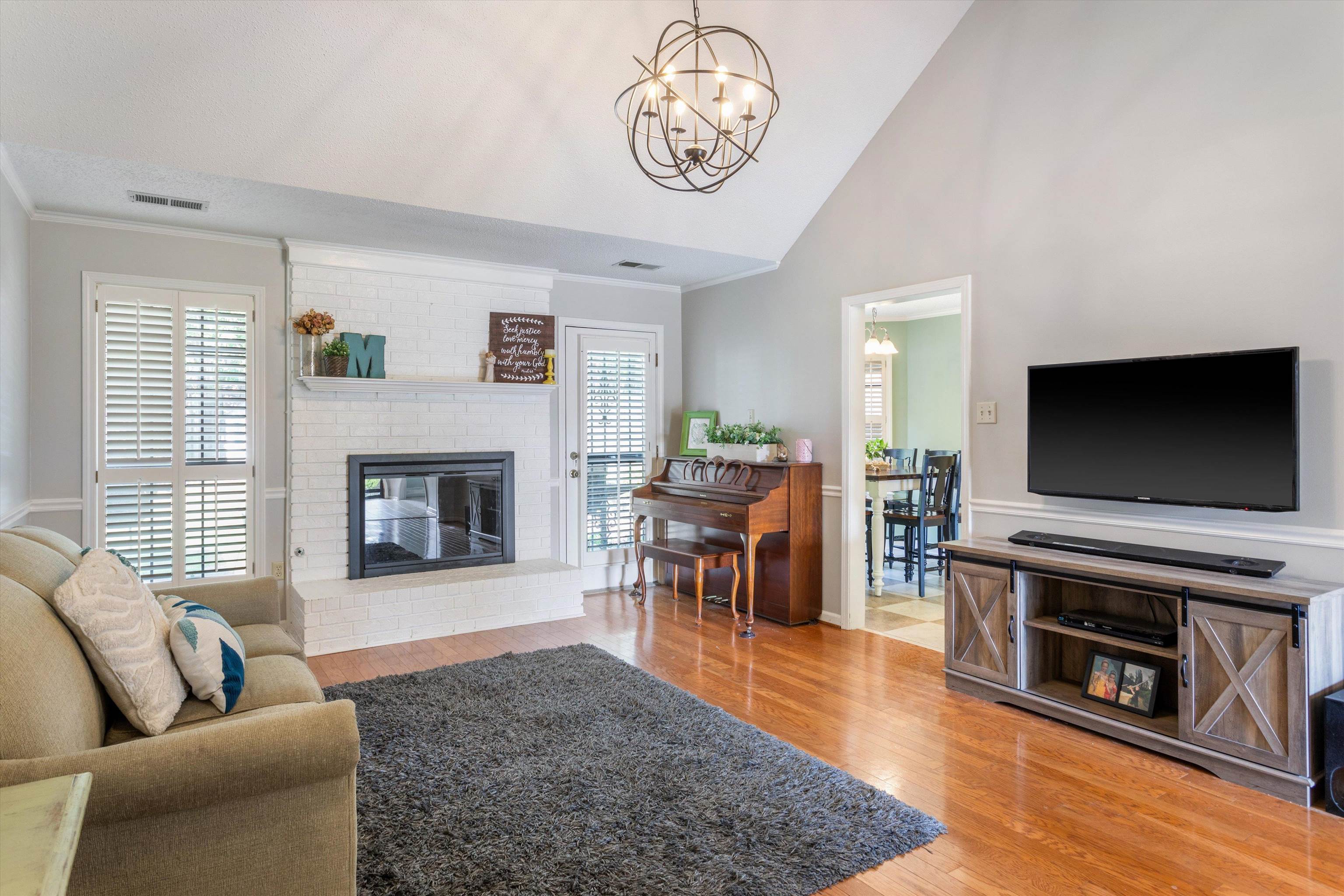6614 Stephan Ridge Cove Bartlett, TN 38135 - Photo 3 of 26 a living room with furniture a flat screen tv and a fireplace