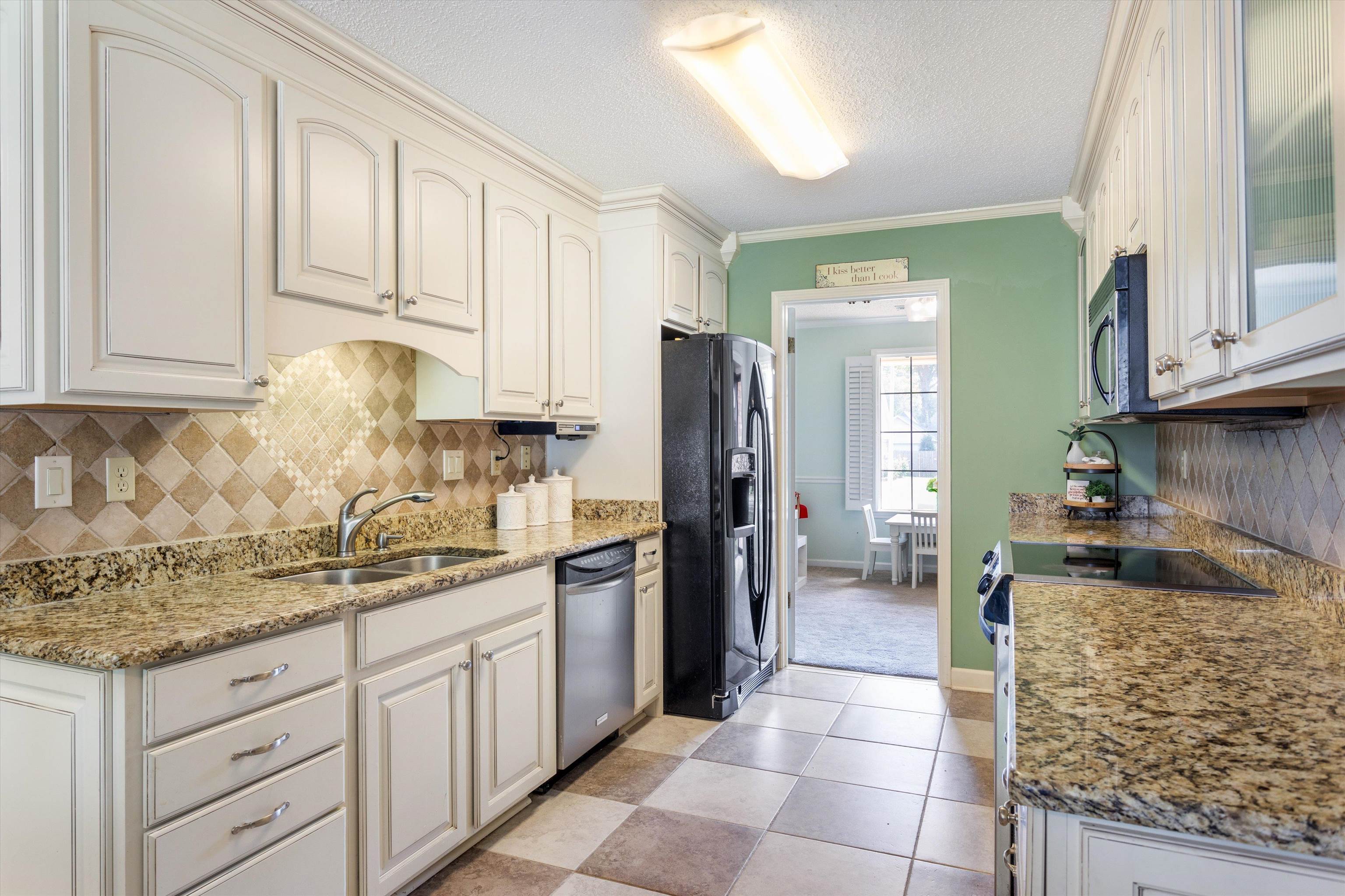 6614 Stephan Ridge Cove Bartlett, TN 38135 - Photo 6 of 26 a kitchen with stainless steel appliances granite countertop a stove refrigerator and cabinets