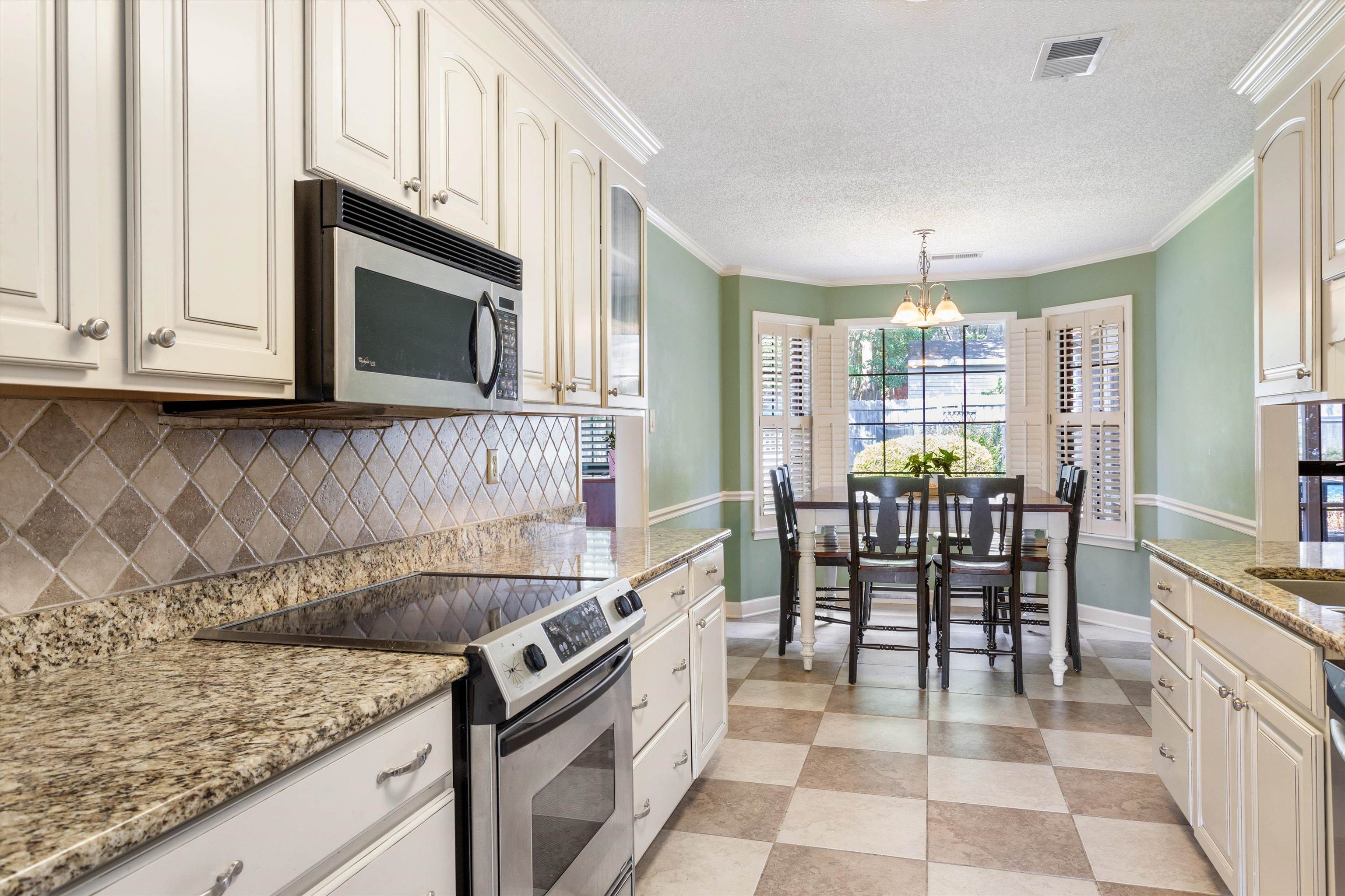 6614 Stephan Ridge Cove Bartlett, TN 38135 - Photo 7 of 26 a kitchen with stainless steel appliances granite countertop a stove a sink and a microwave