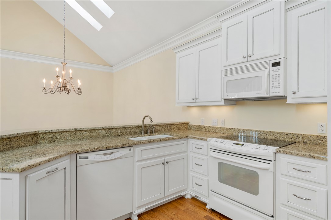 16 Oleander Drive Anderson, SC 29621 - Photo 14 of 37 Vast vaulted ceilings and skylights illuminate a well-appointed kitchen featuring granite counters and hardwood floors.