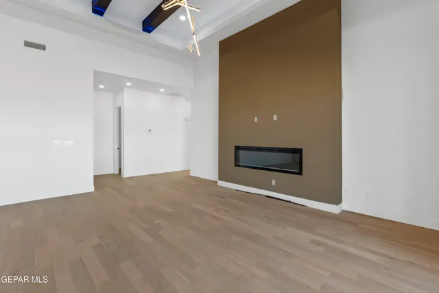 a room with kitchen island stainless steel appliances a sink and refrigerator