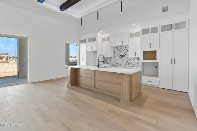 a bathroom with double vanity sink and shower