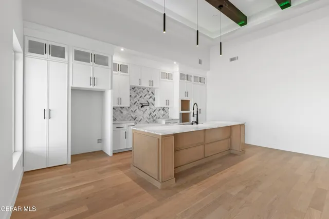 a room with a sink and a wooden floor
