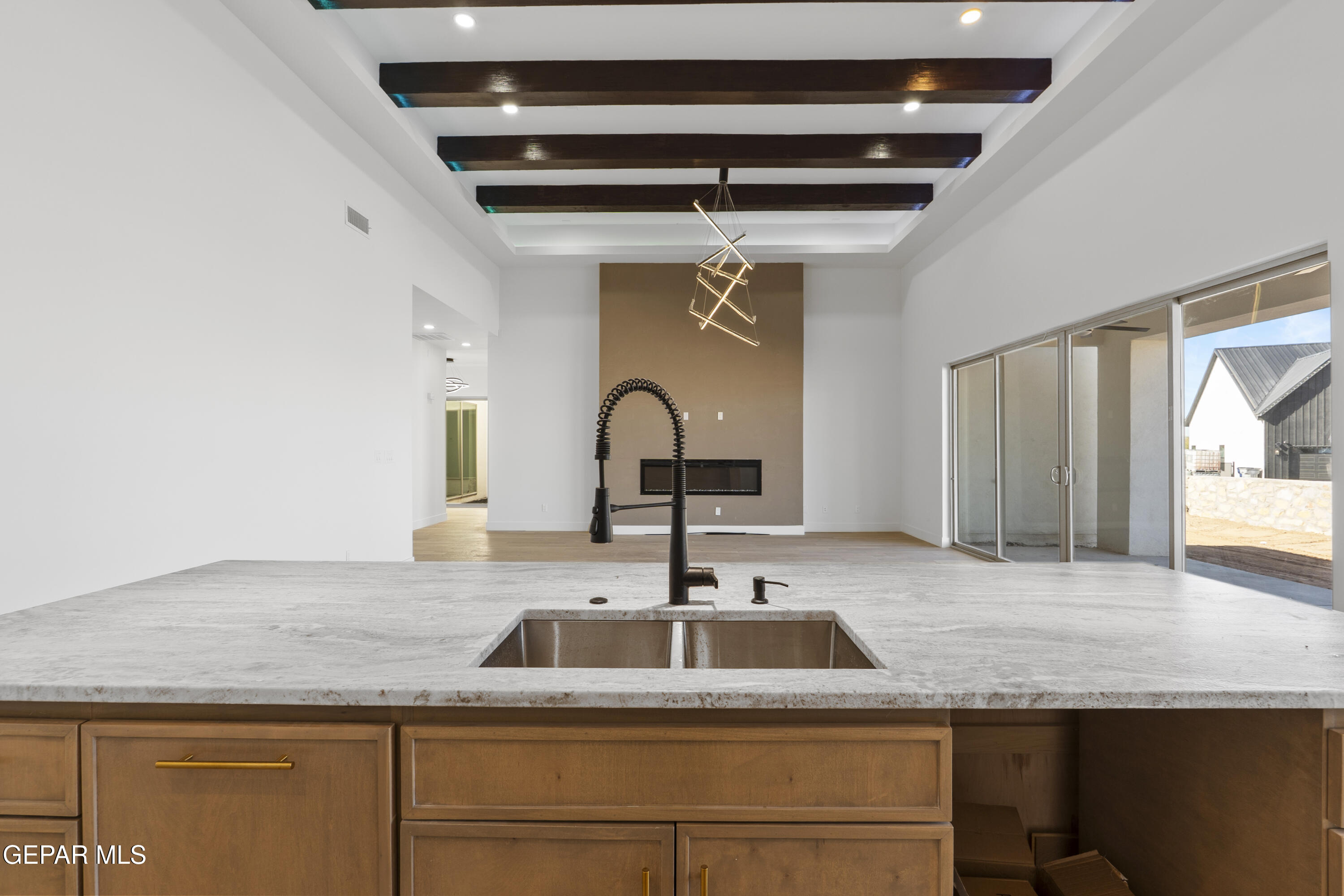 5659 Rio Bonito Circle El Paso, TX 79932 - Photo 18 of 55 a kitchen with granite countertop a sink and a wooden floor