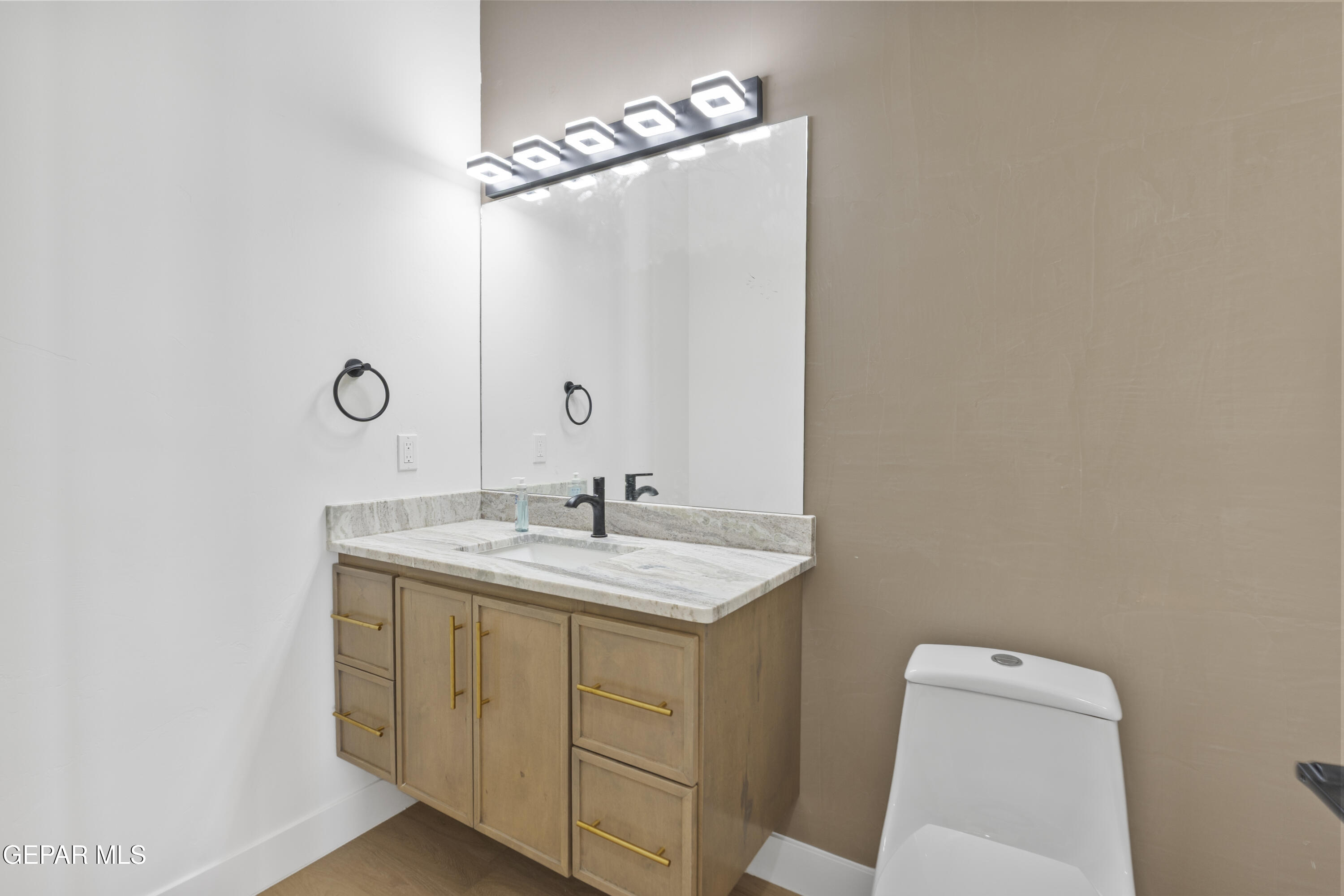 5659 Rio Bonito Circle El Paso, TX 79932 - Photo 25 of 55 a bathroom with a granite countertop sink toilet and mirror