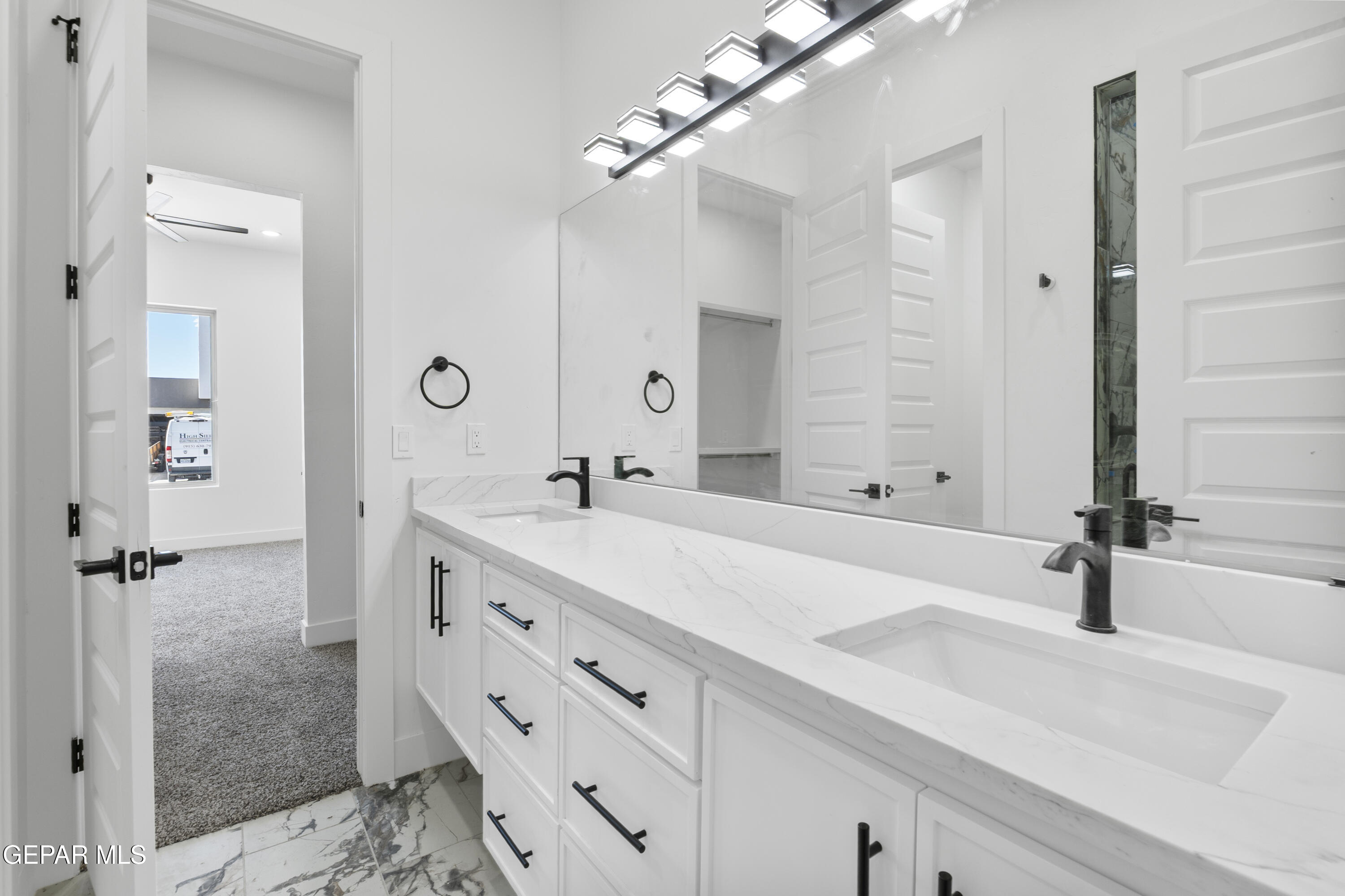 5659 Rio Bonito Circle El Paso, TX 79932 - Photo 28 of 55 a bathroom with a double vanity sink a mirror and shower