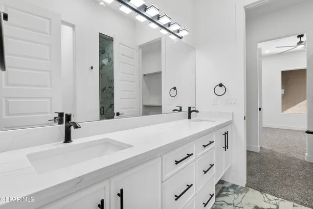 an empty room with a window and a ceiling fan