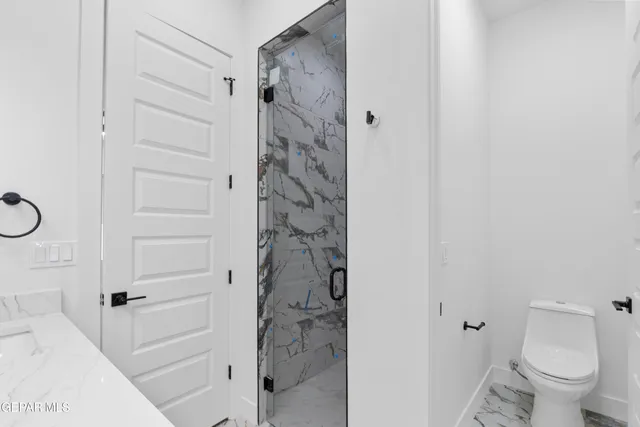 an empty room with a ceiling fan and carpet