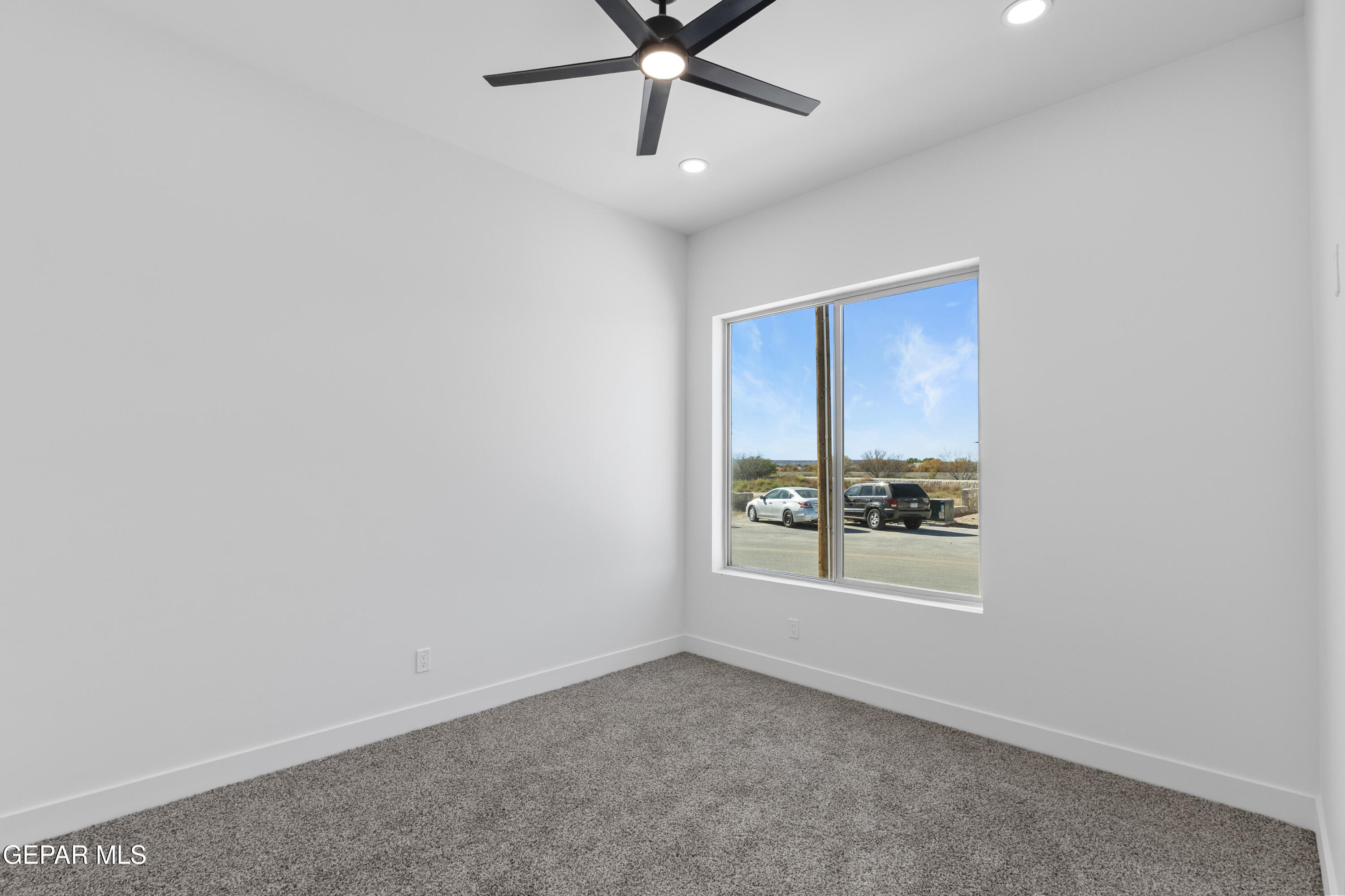 5659 Rio Bonito Circle El Paso, TX 79932 - Photo 33 of 55 an empty room with a window and a ceiling fan