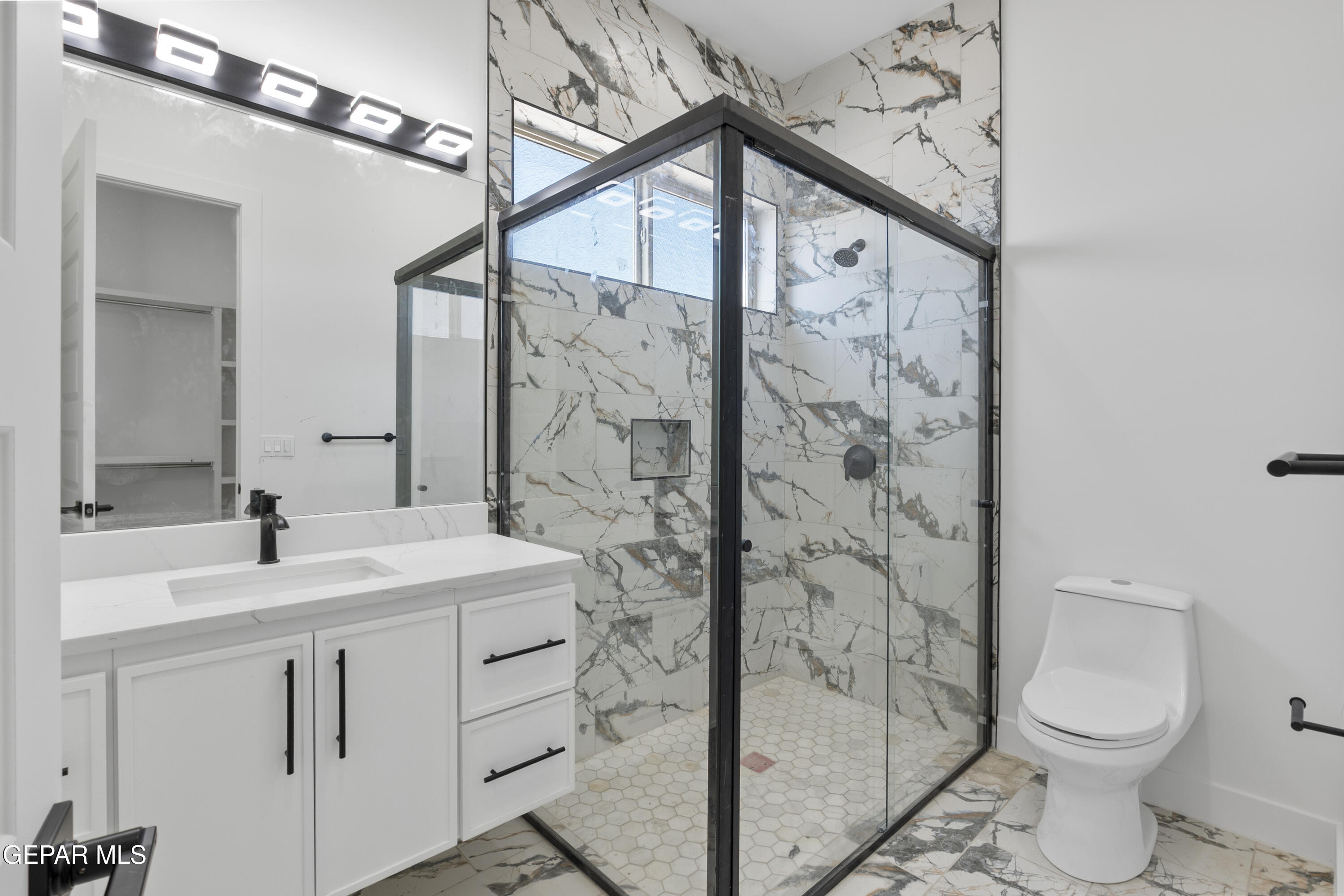 5659 Rio Bonito Circle El Paso, TX 79932 - Photo 38 of 55 a bathroom with a sink a toilet and shower