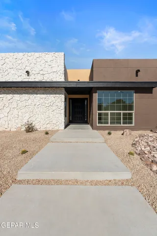 a bedroom with a bed and glass door