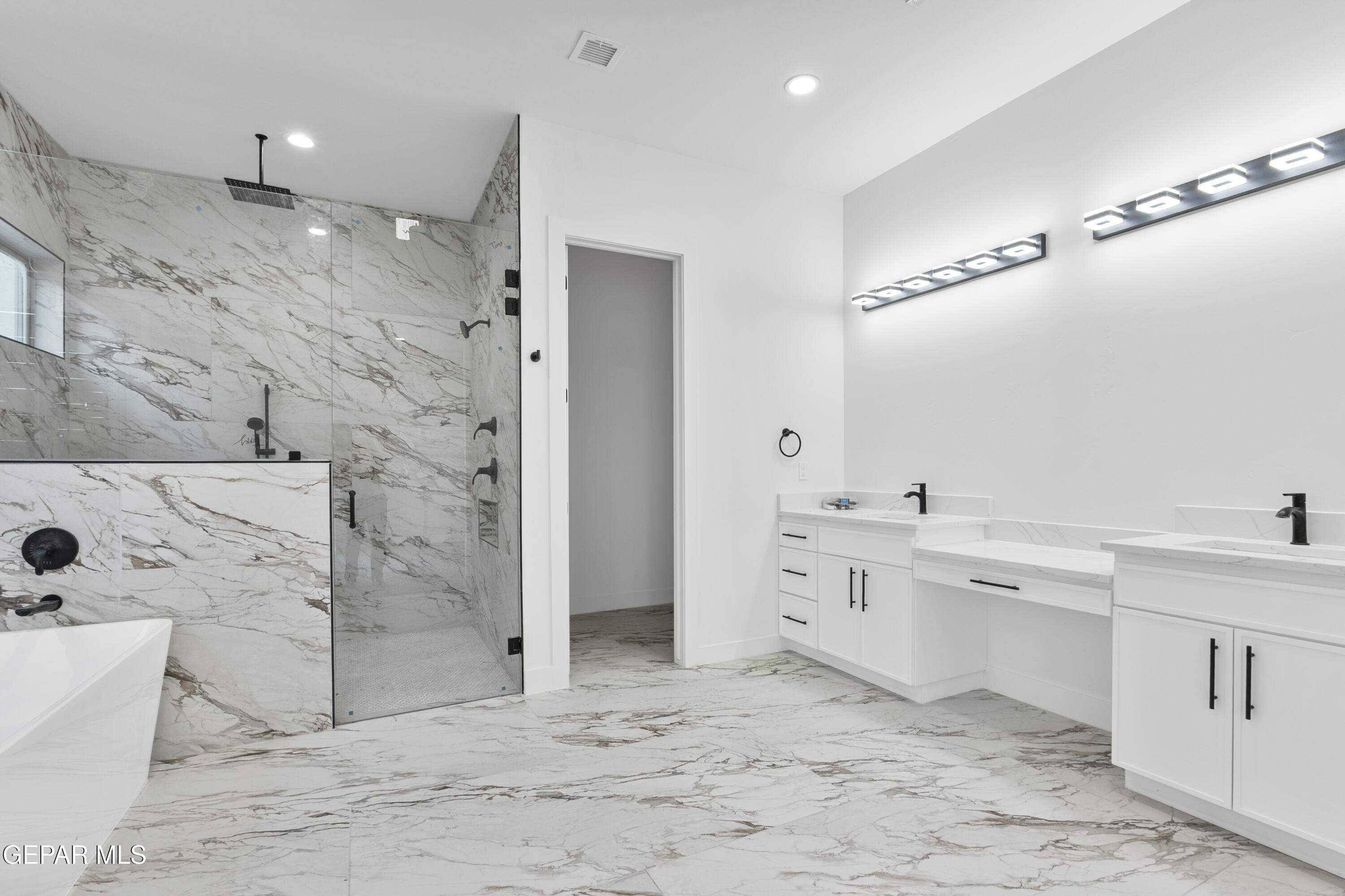 5659 Rio Bonito Circle El Paso, TX 79932 - Photo 45 of 55 a large bathroom with a sink mirror and a bath tub