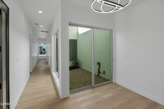 a view of a room with wooden floor