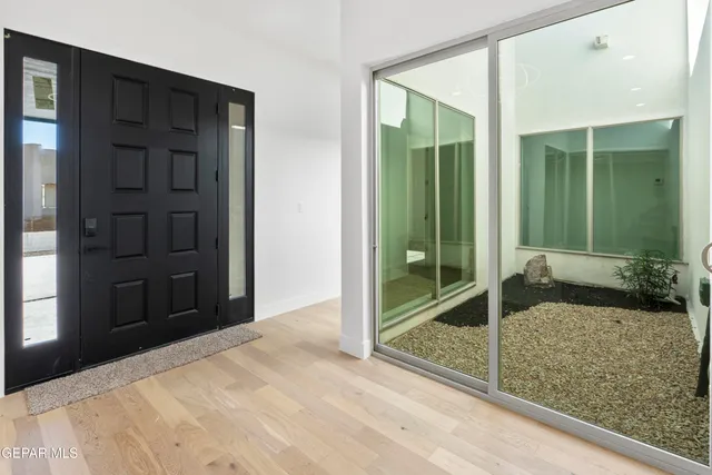 a view of a livingroom with wooden floor and a flat screen tv
