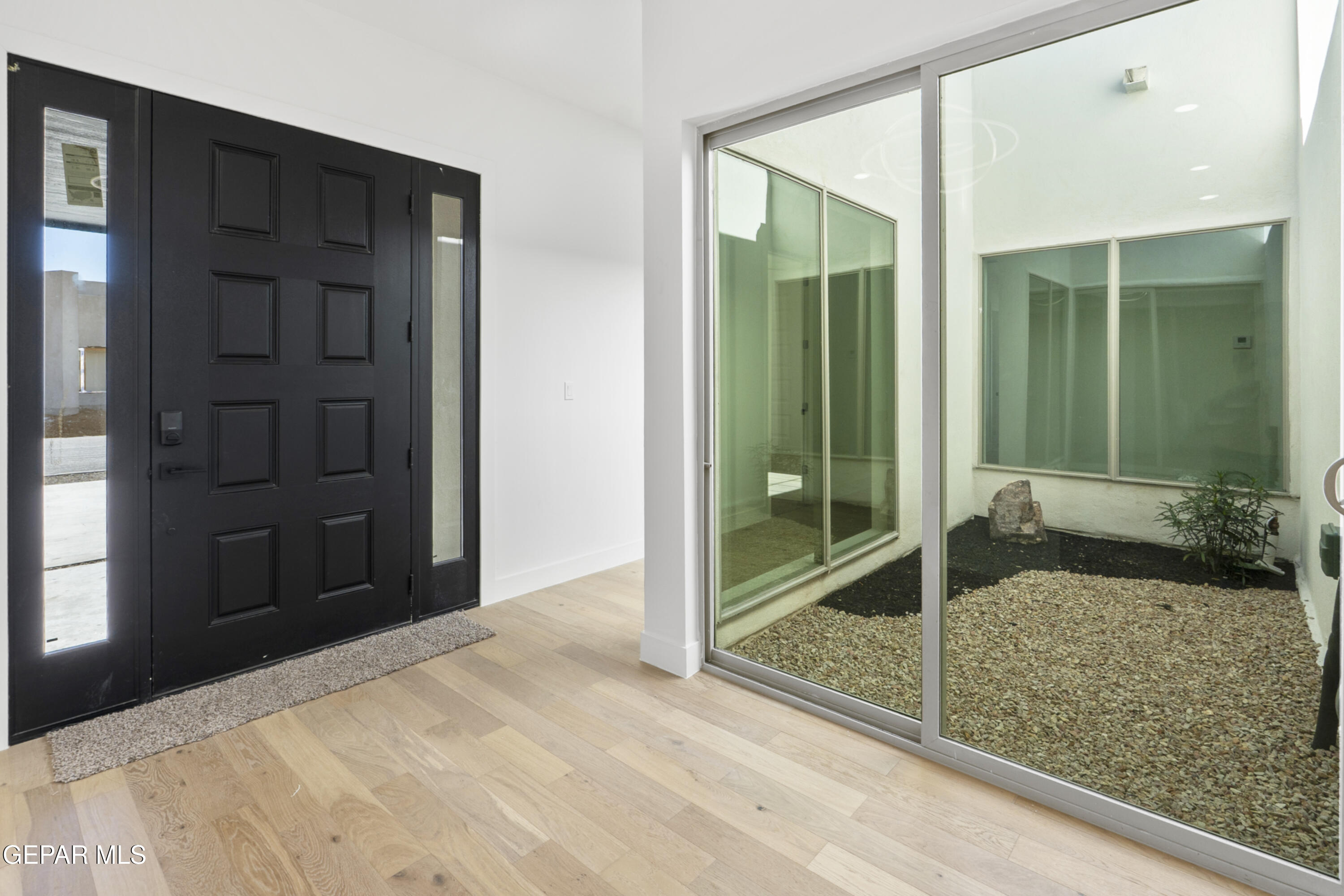 5659 Rio Bonito Circle El Paso, TX 79932 - Photo 6 of 55 a bedroom with a bed and glass door