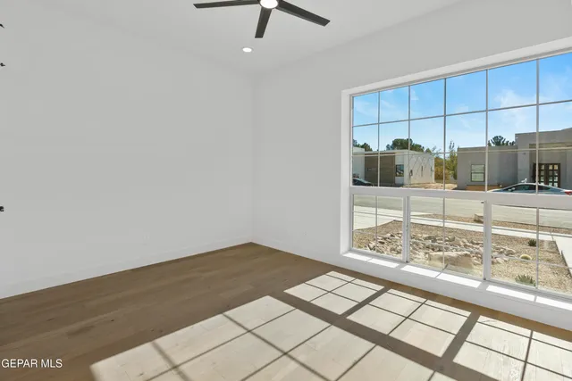 a view of an empty room with kitchen