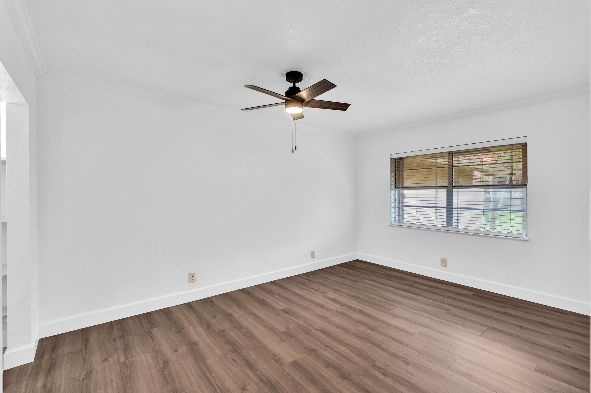 1291 Northwest 13th Street, Unit 445D Boca Raton, FL 33486 - Photo 30 of 50 wooden floor in an empty room with a window
