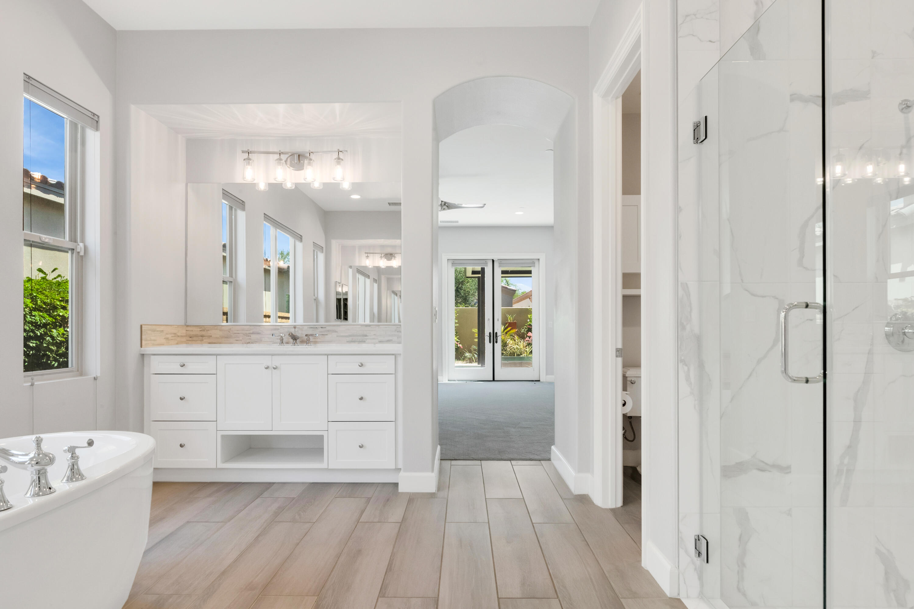 81925 Four Seasons Place La Quinta, CA 92253 - Photo 20 of 27 a spacious bathroom with a granite countertop sink mirror and bathtub