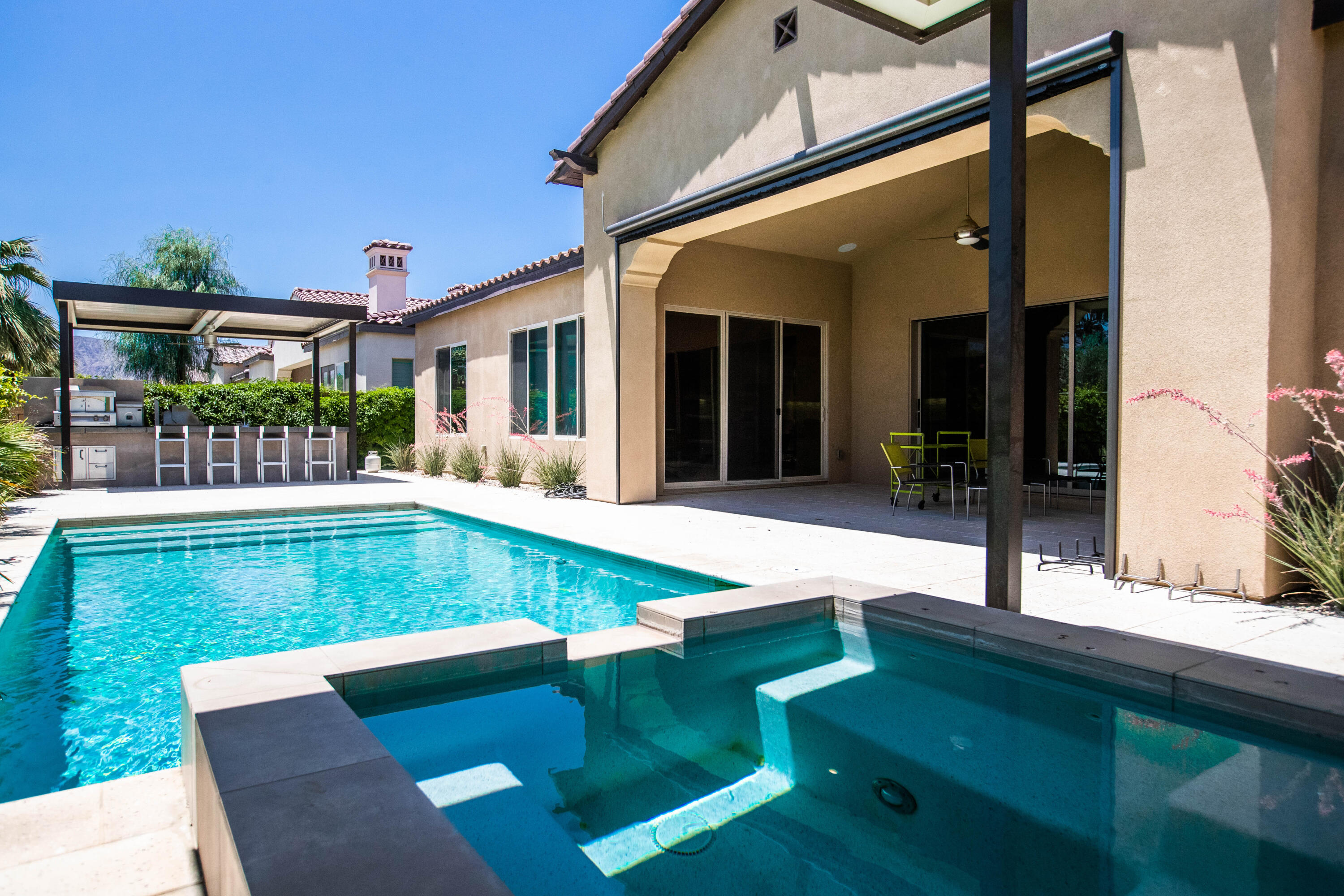 81925 Four Seasons Place La Quinta, CA 92253 - Photo 4 of 27 a view of an house with backyard porch and furniture