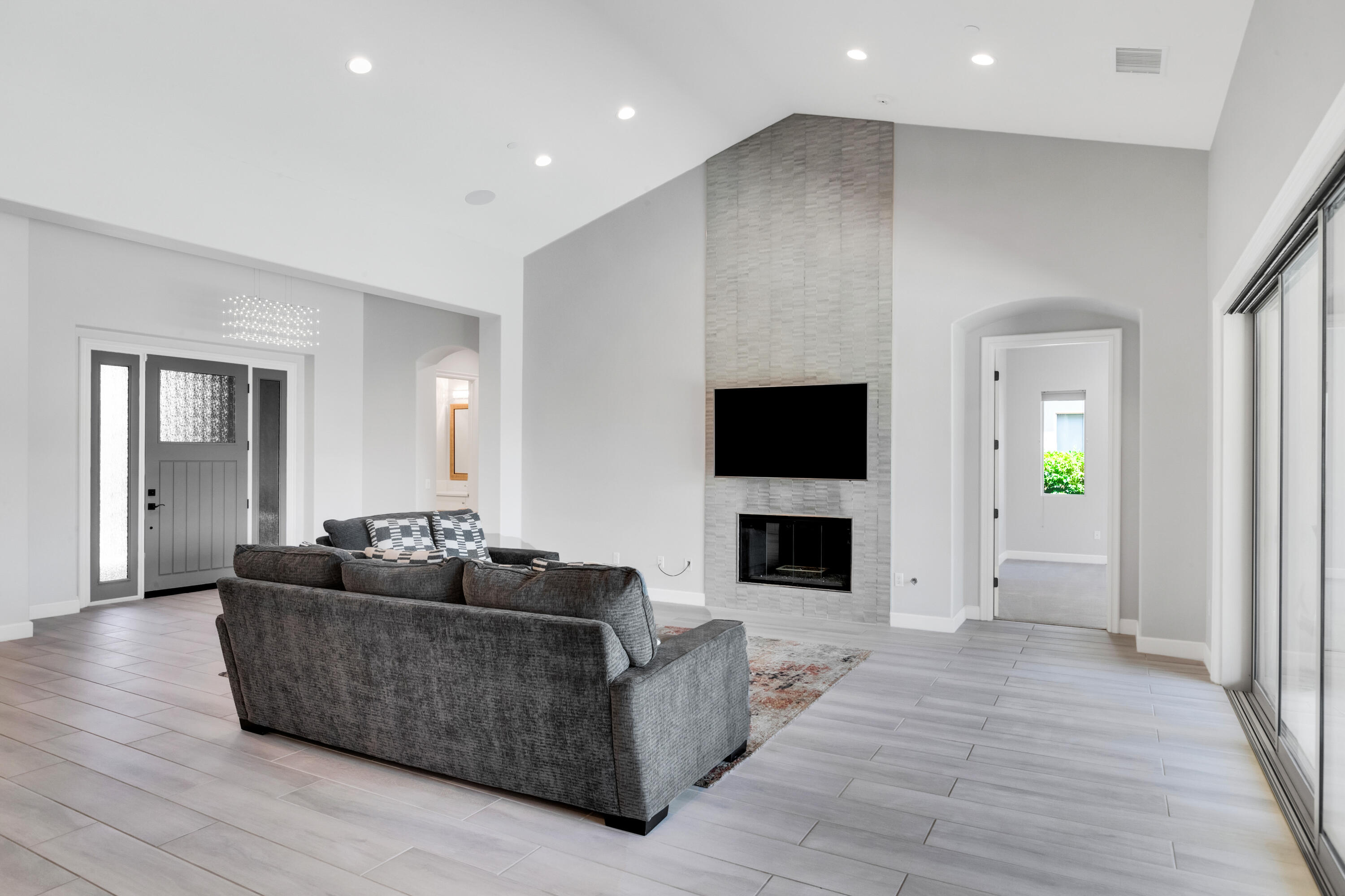 81925 Four Seasons Place La Quinta, CA 92253 - Photo 8 of 27 a living room with furniture a flat screen tv and a fireplace