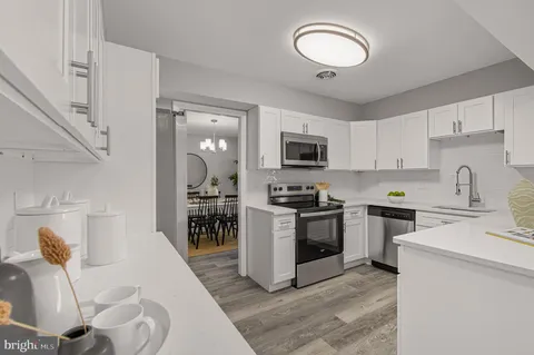 a kitchen with a sink a stove and cabinets
